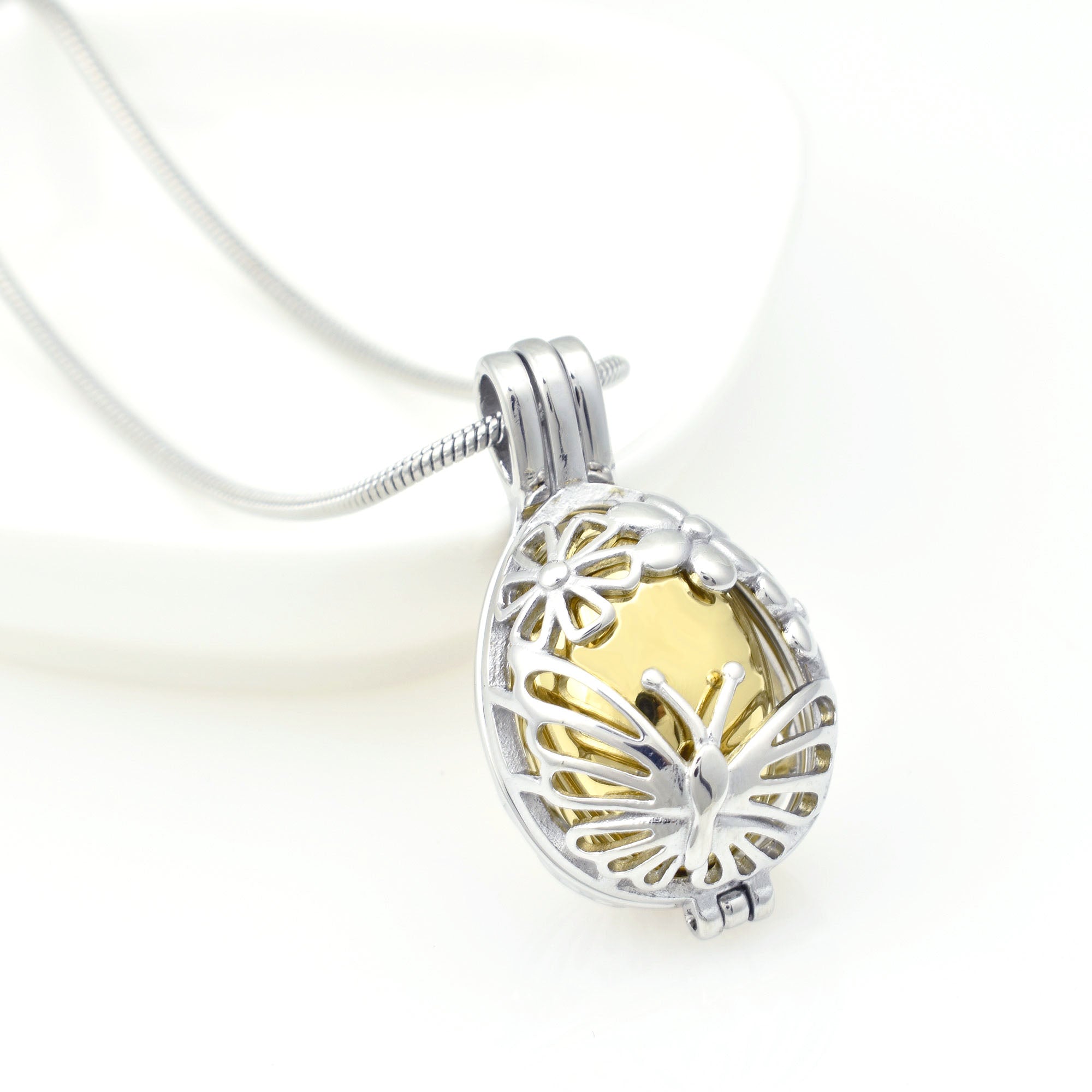 Close Up of Gold Floral Urn Locket with Butterflies