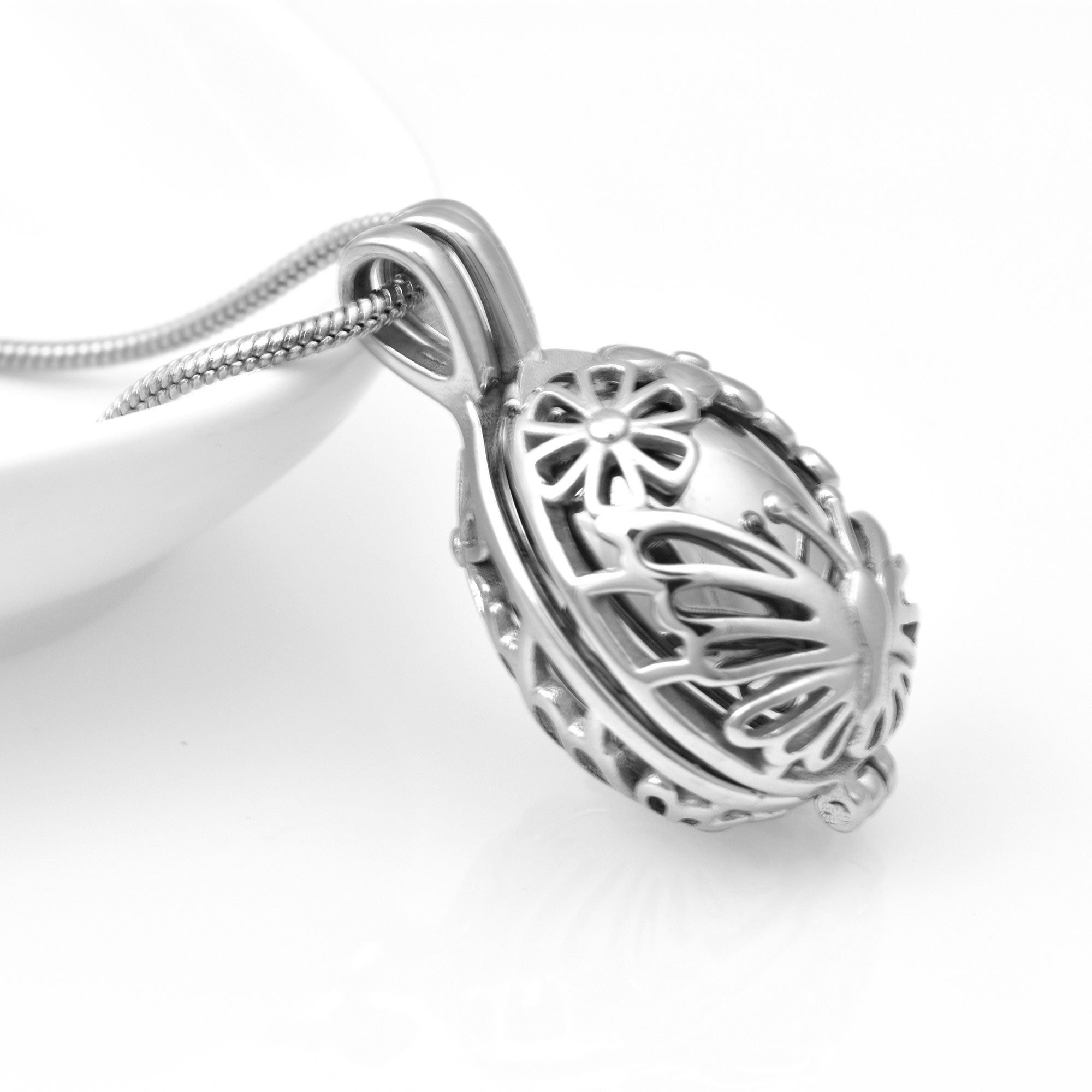 Side View of Silver Locket with Butterflies and Flowers